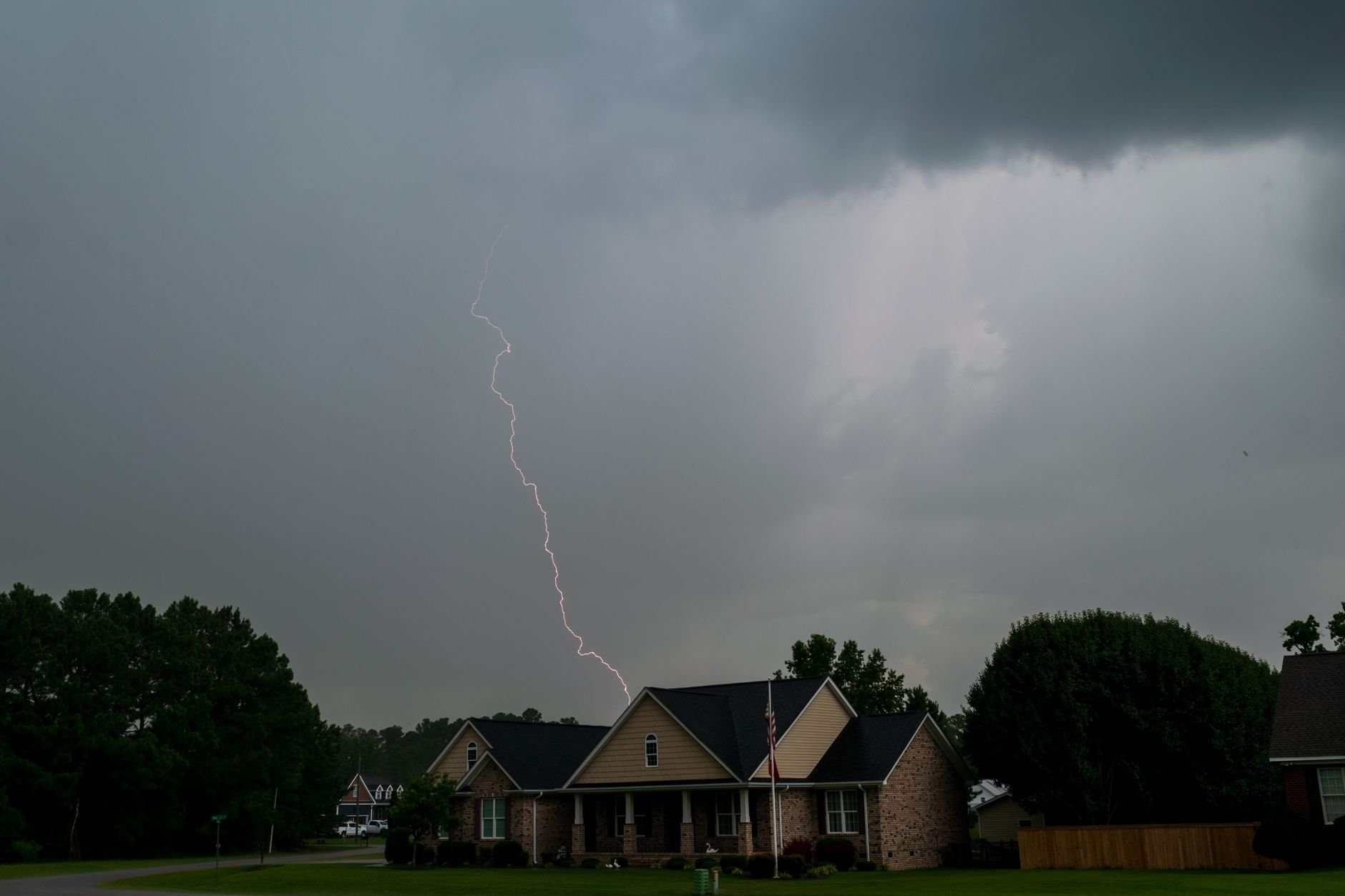 Lightning over suburban houses during a storm